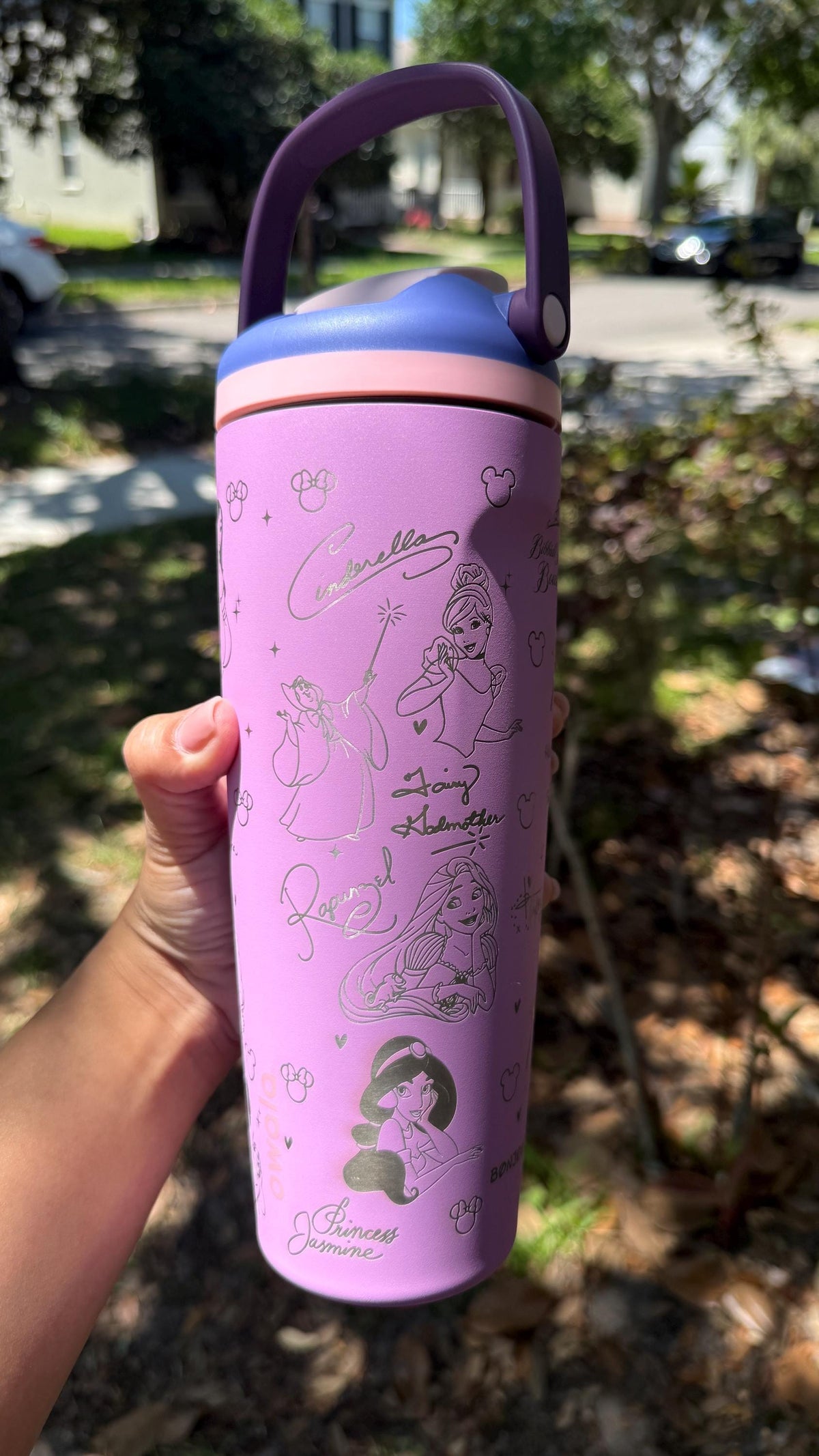 Lilac engraved Owala Sway tumbler held outdoors