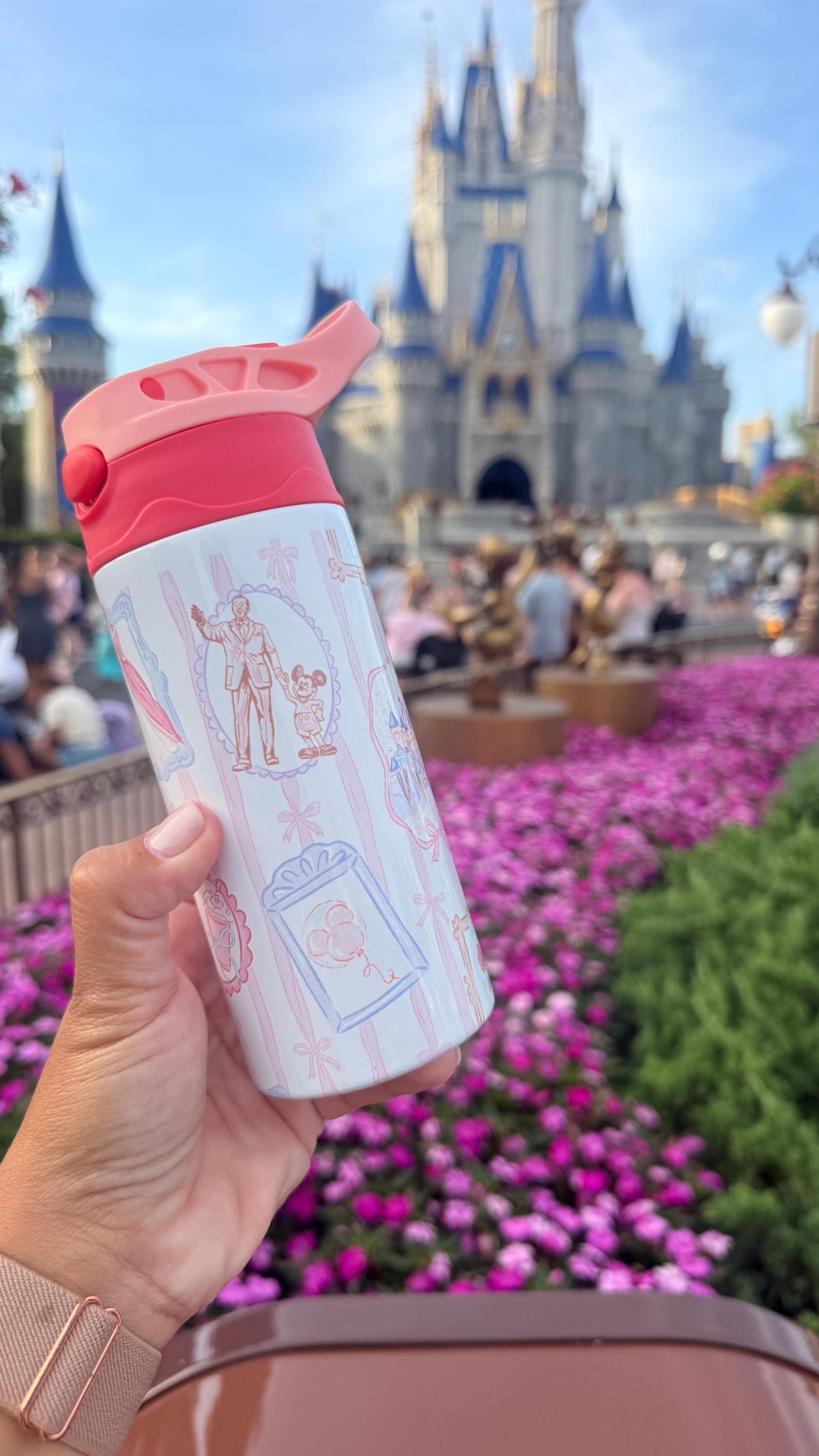 Side view of a kids castle water bottle with pink details