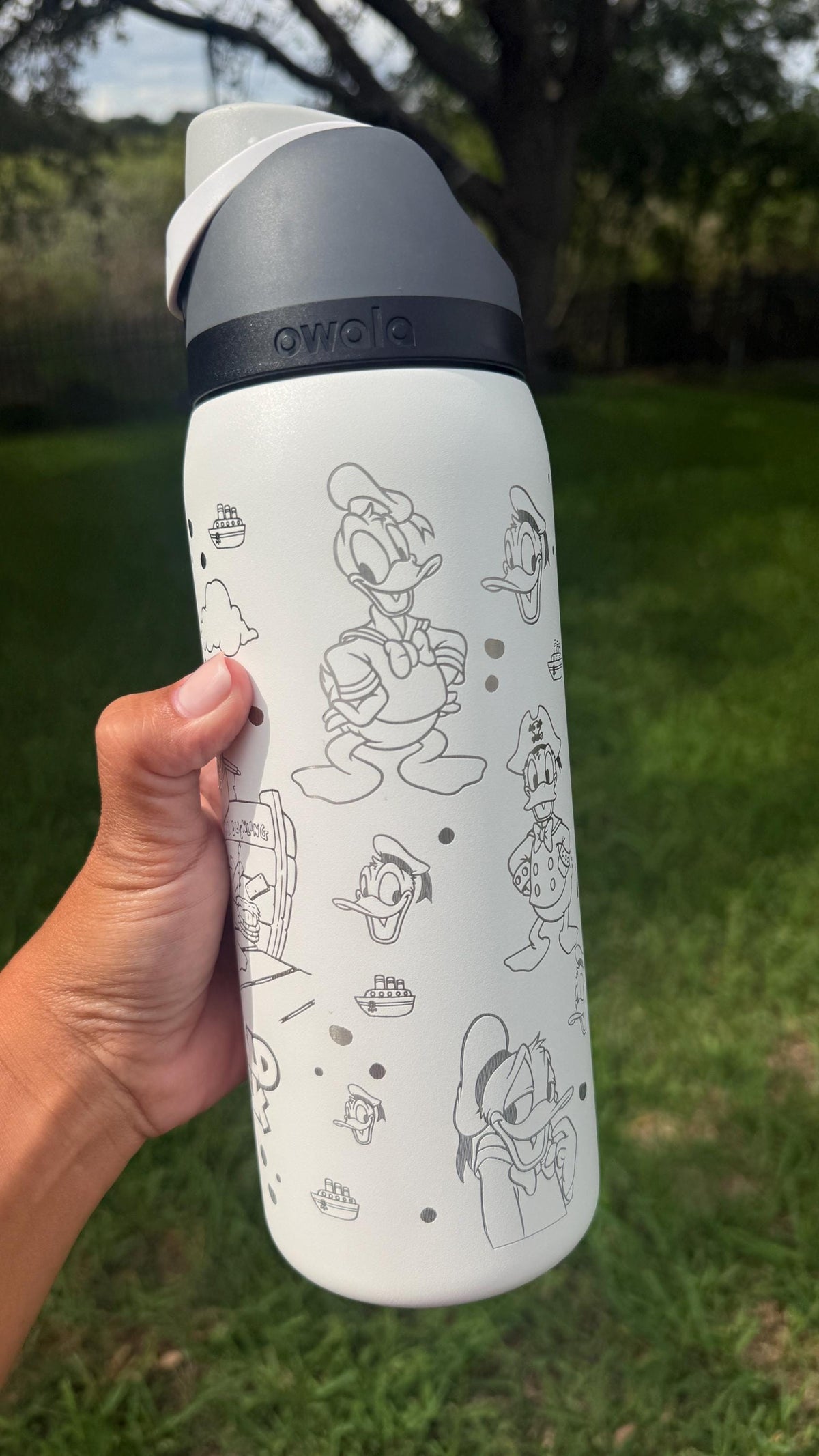 Back of a white Owala with more laser engraved Donald Duck artwork