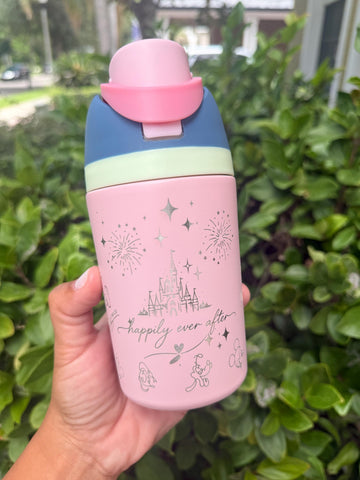 Pink 12 oz kids FreeSip water bottle laser engraved with a castle and character signatures