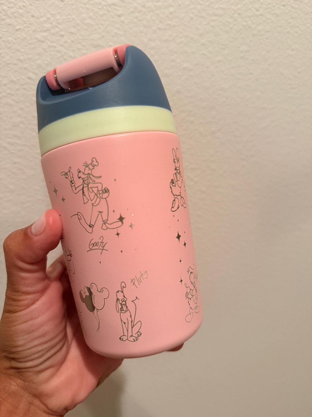 Coral pink kids FreeSip bottle with navy lid and engraved character signatures