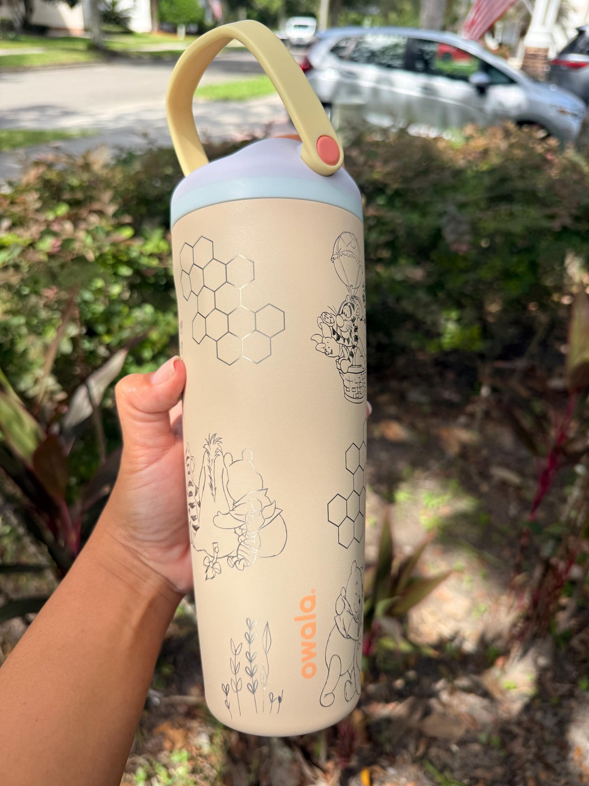 Back of a cream Owala Sway showing more Pooh-inspired engraving