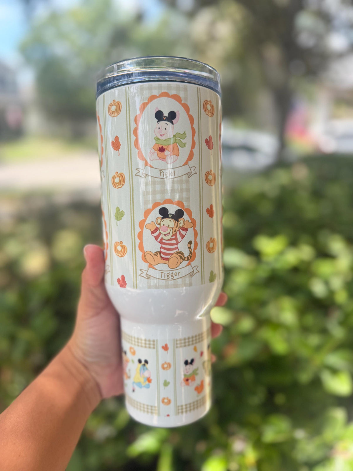 Close-up of Pooh and autumn floral print on a 40 oz tumbler