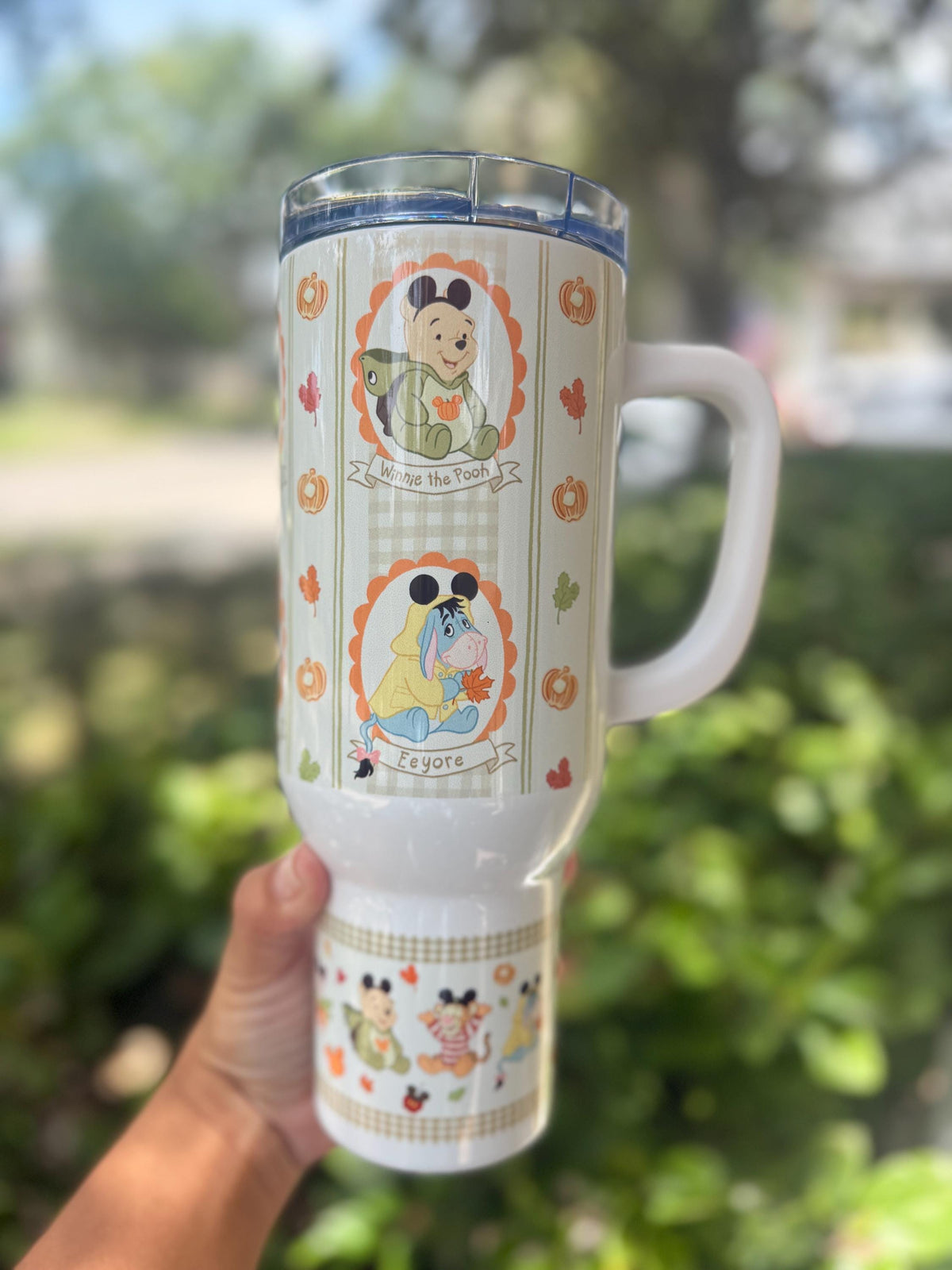 Side view of a Winnie the Pooh fall printed tumbler with handle