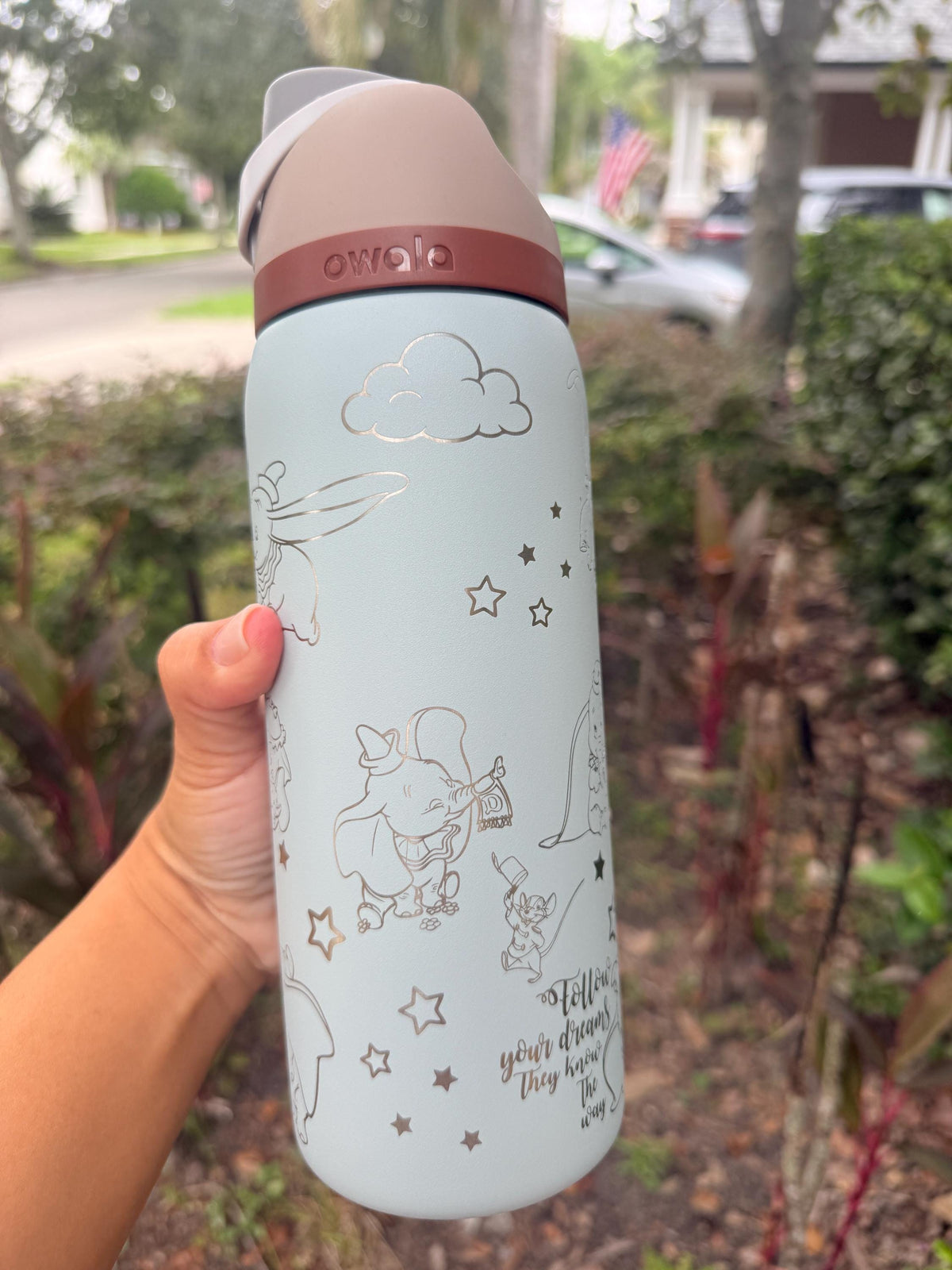 Close-up of Dumbo-inspired elephant engraving on a light blue Owala