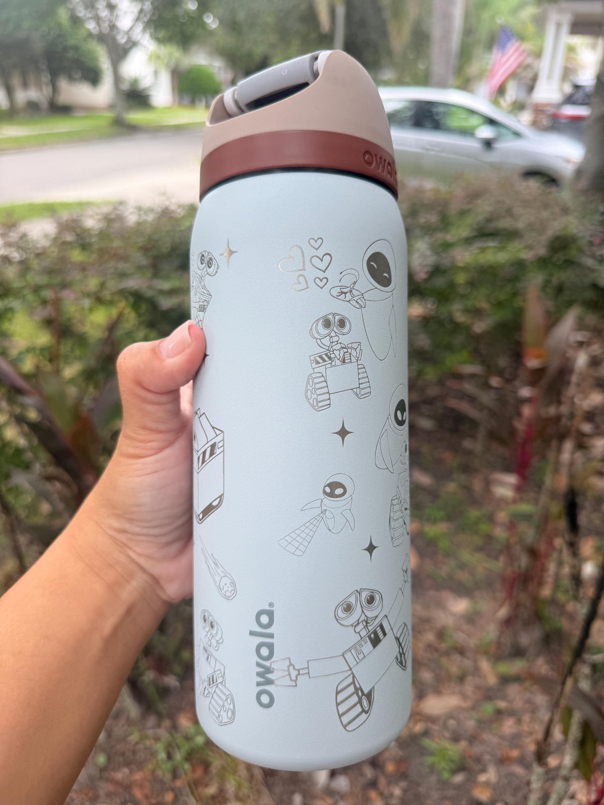 Light blue Owala FreeSip with engraved WALL-E details and plant