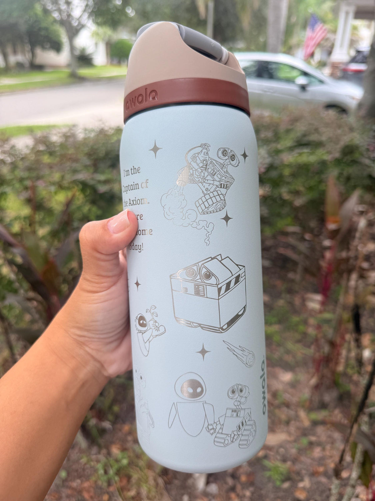 Close-up of WALL-E and EVE-inspired engraving on a light blue Owala