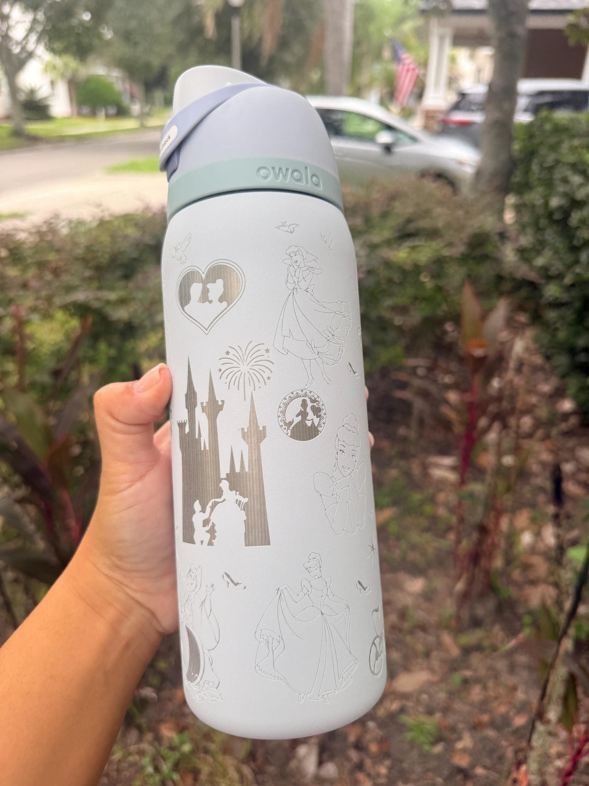 Back of a white Owala showing more Cinderella-inspired engraved artwork