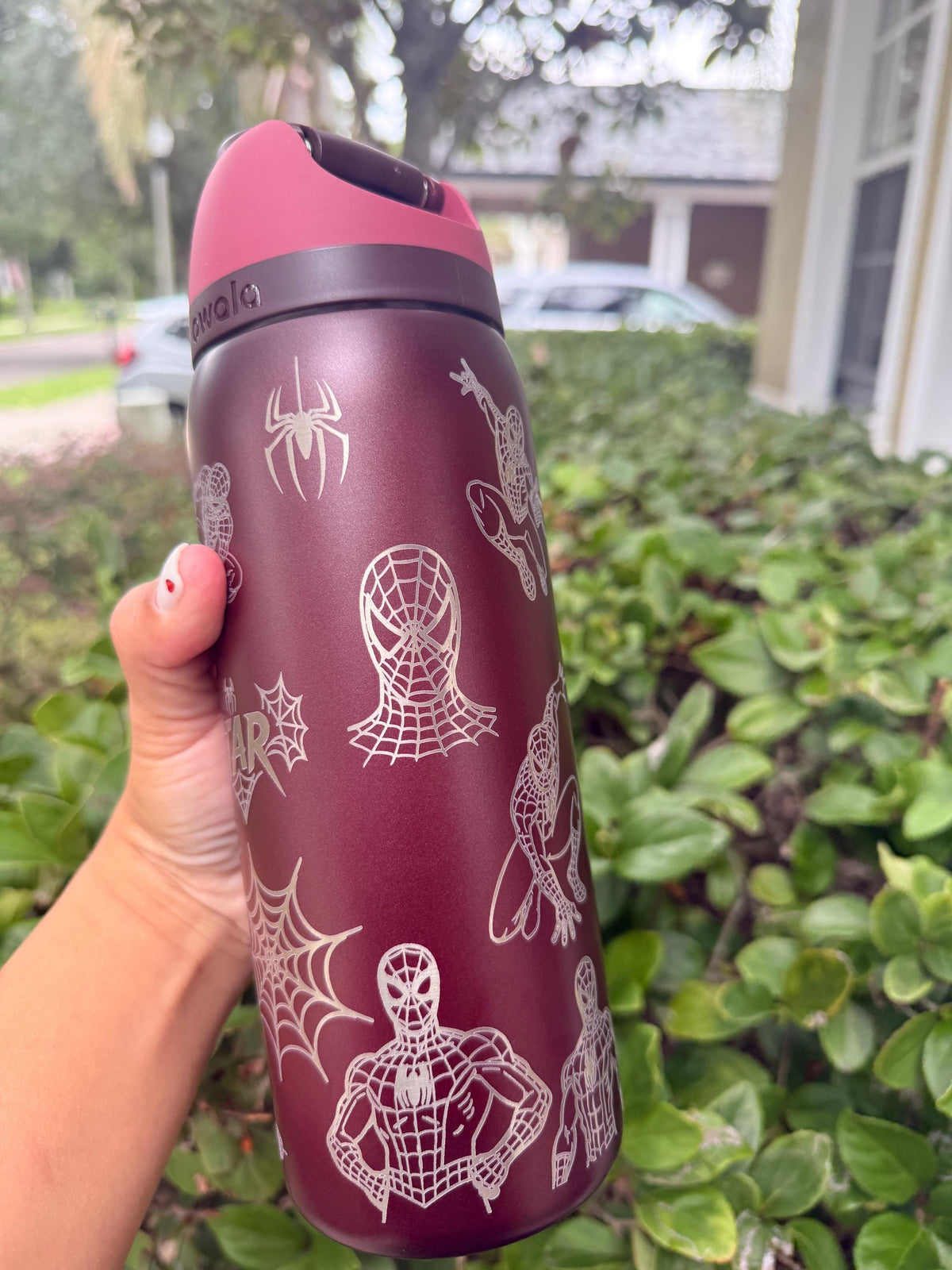 Spider-Man figure engraved on a burgundy Owala water bottle
