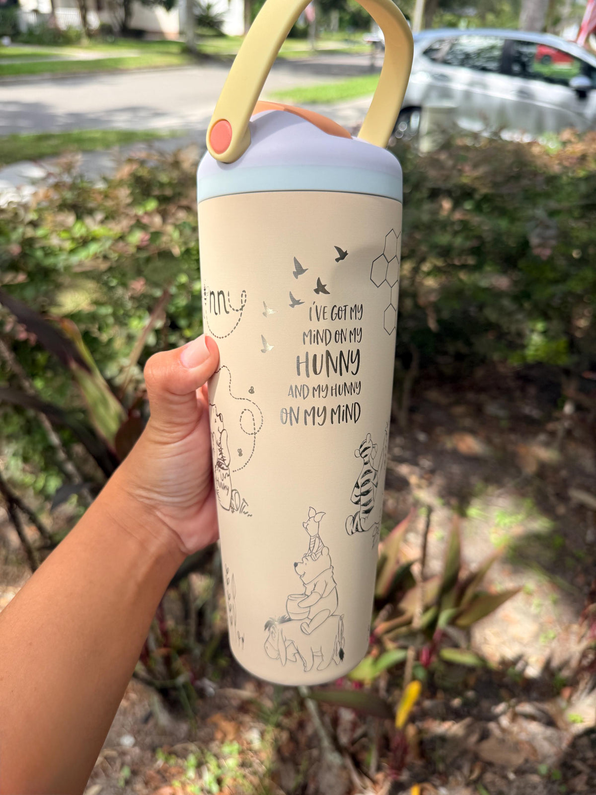 Side view of a cream Owala Sway with engraved Pooh quote
