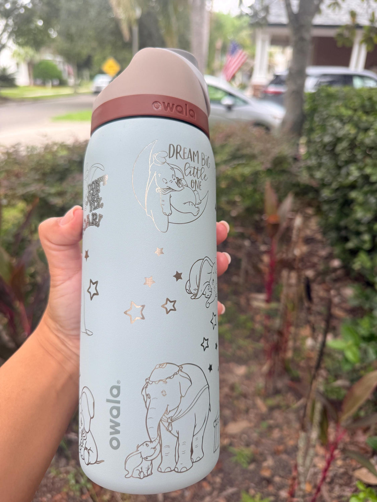 Side view of a light blue engraved Owala with the Owala logo