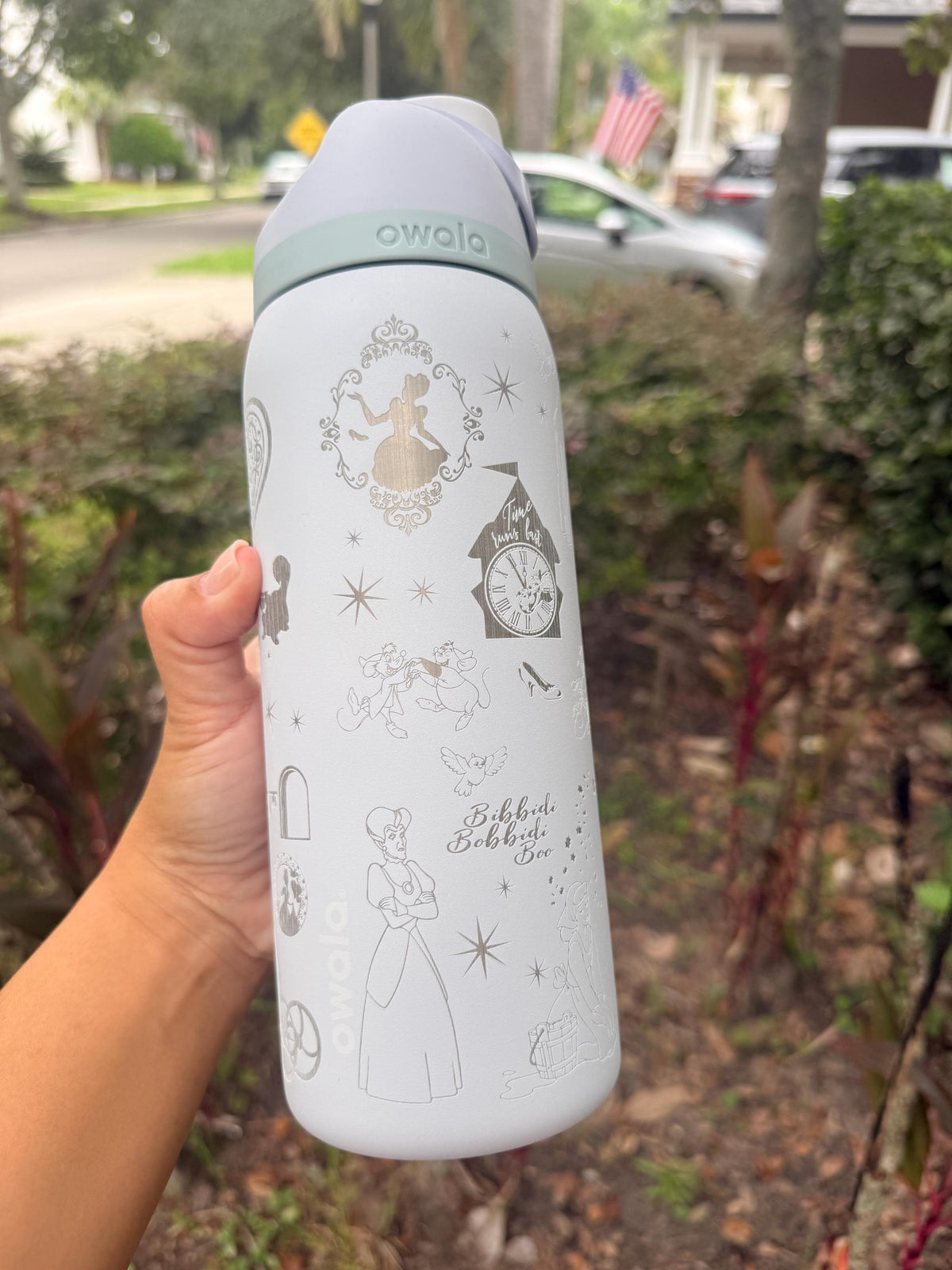 Close-up of Cinderella-inspired engraving on a white Owala water bottle