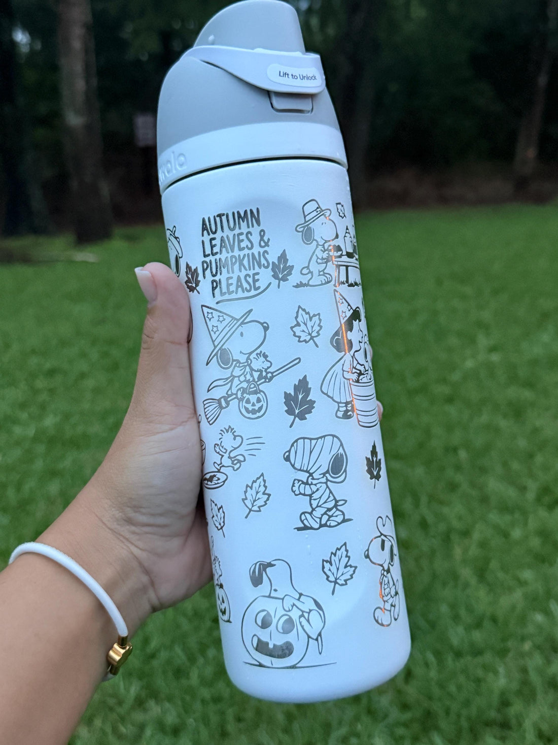 Light blue Owala FreeSip laser engraved with Snoopy fall and Halloween designs