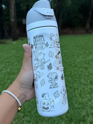 Light blue Owala FreeSip laser engraved with Snoopy fall and Halloween designs