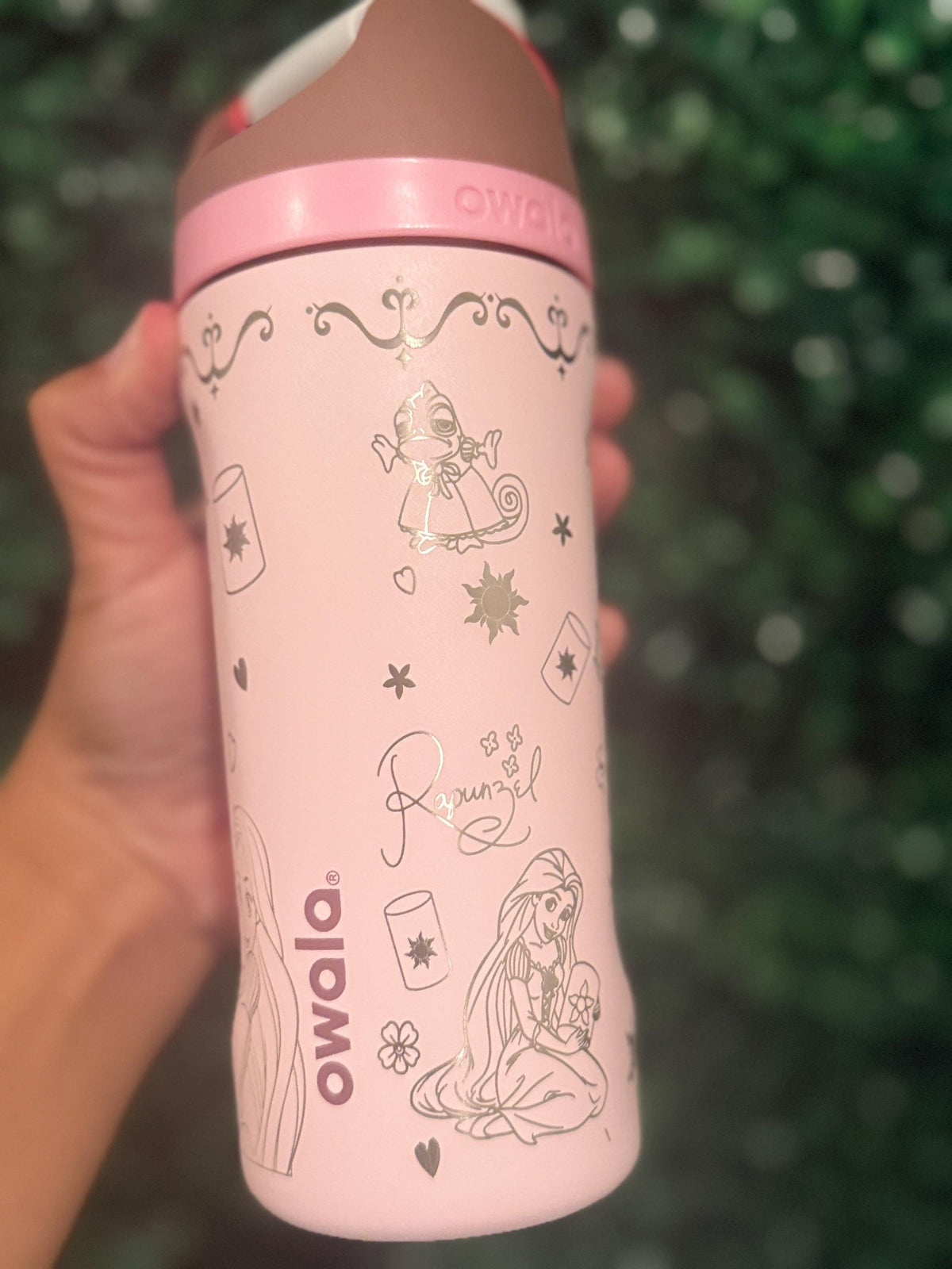 Close-up of sun and floral details engraved on a pink Owala