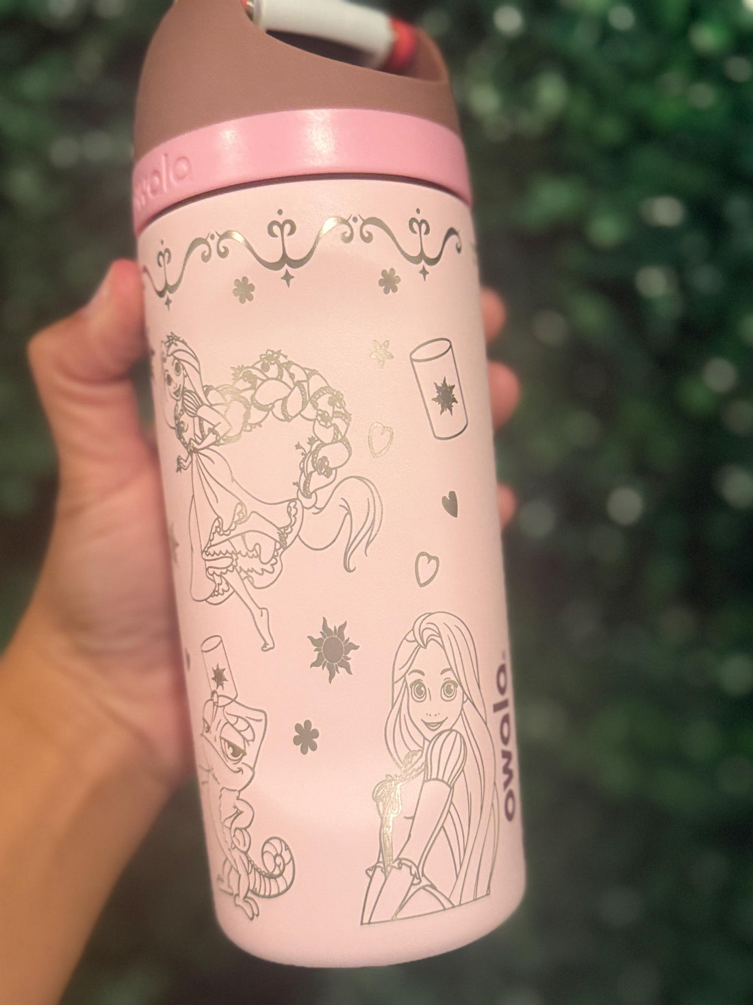Light pink Owala FreeSip laser engraved with a Rapunzel-inspired design