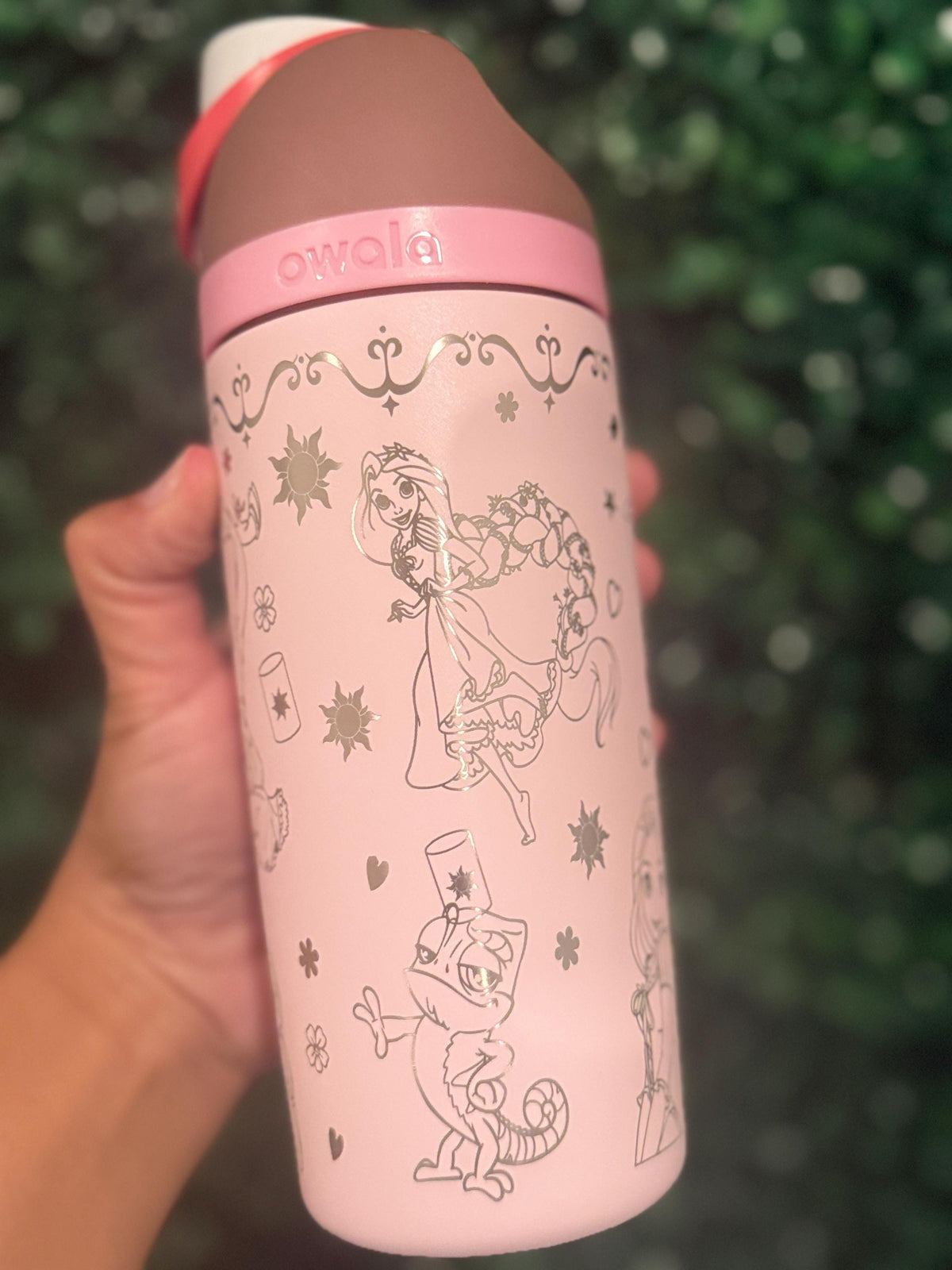 Back of a pale pink Owala showing more Rapunzel-inspired engraved details