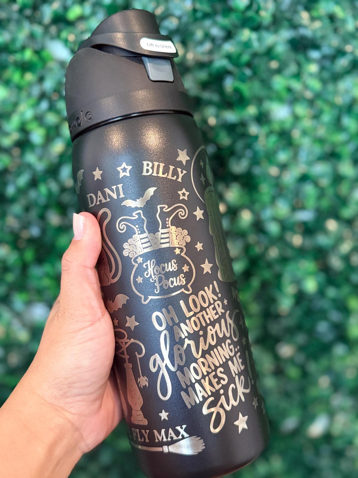 Side view of a black Owala bottle engraved with witches and Halloween icons